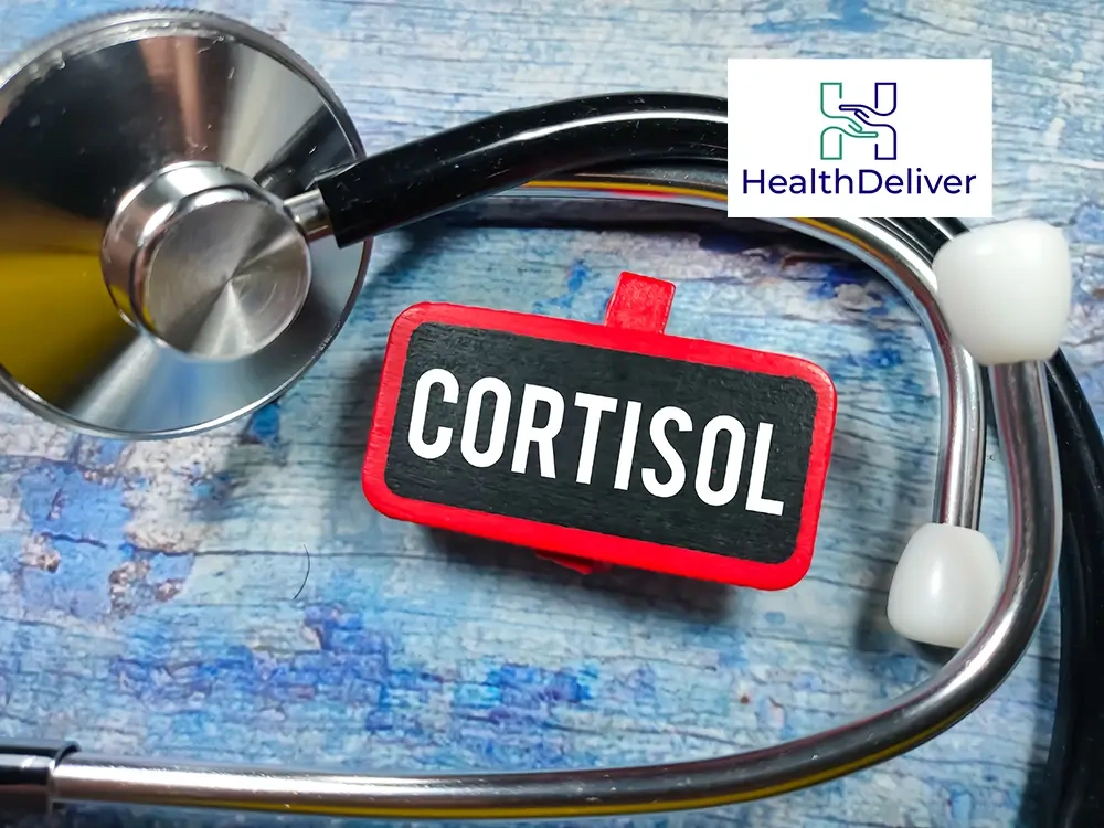 Stethoscope and cortisol label on blue wooden medical background