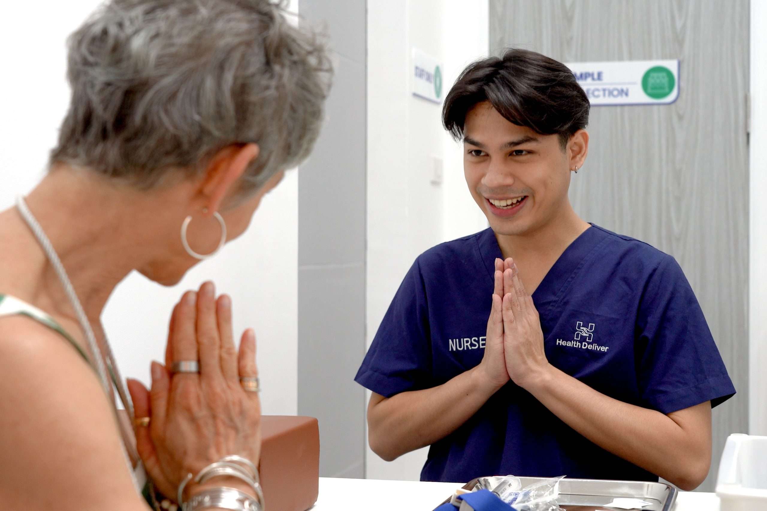Health Articles 5 Nurse greeting patient with respectful Thai wai gesture in clinic