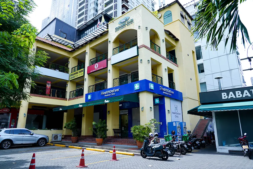 Yellow building with blue pharmacy storefront and parked motorcycles