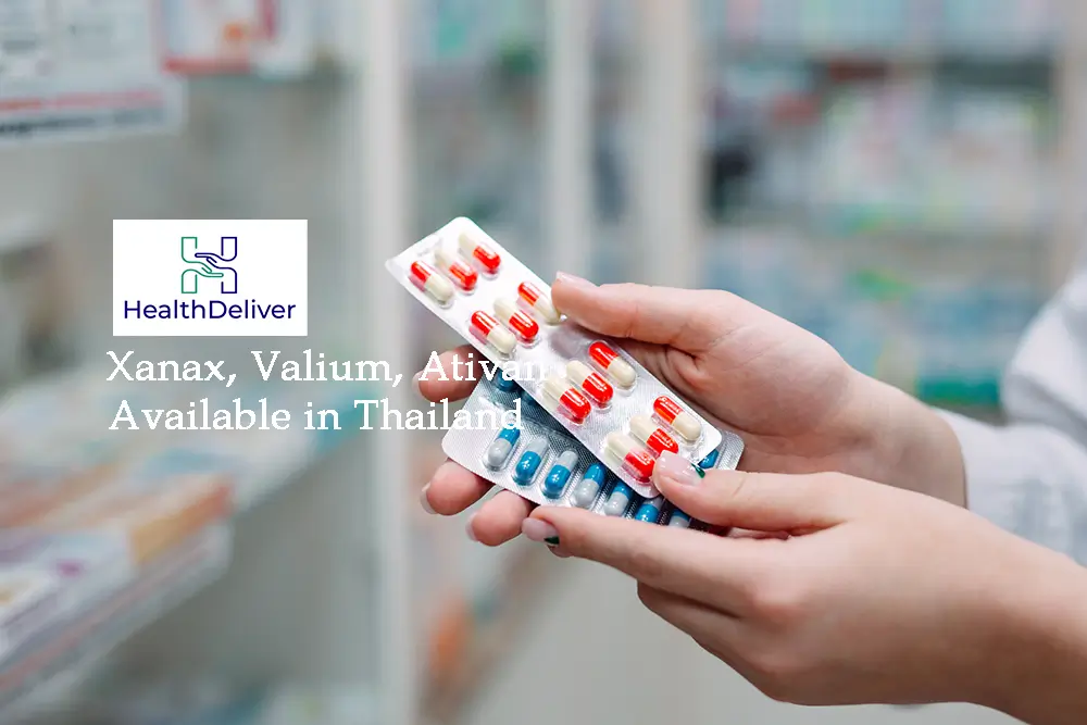 Pharmacist holding red white blue capsule blister packs pharmacy