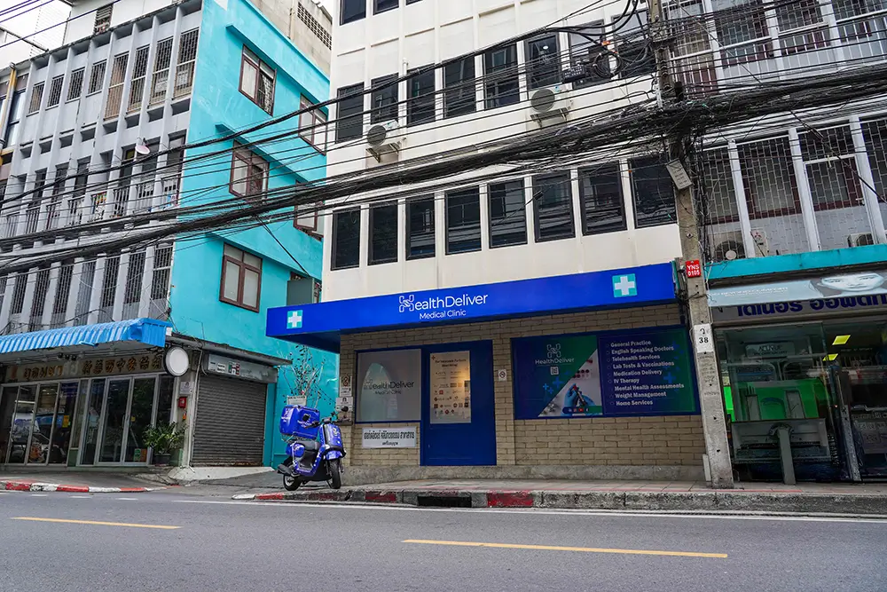 HealthDeliver Medical Clinic storefront on street with blue scooter parked outside