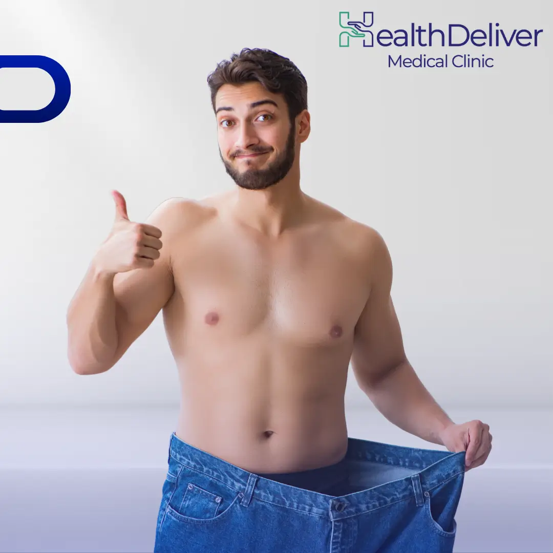 Man showing weight loss results wearing oversized jeans thumbs up