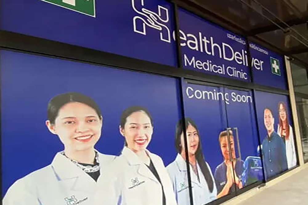 HealthDeliver Medical Clinic storefront window displaying healthcare professionals coming soon