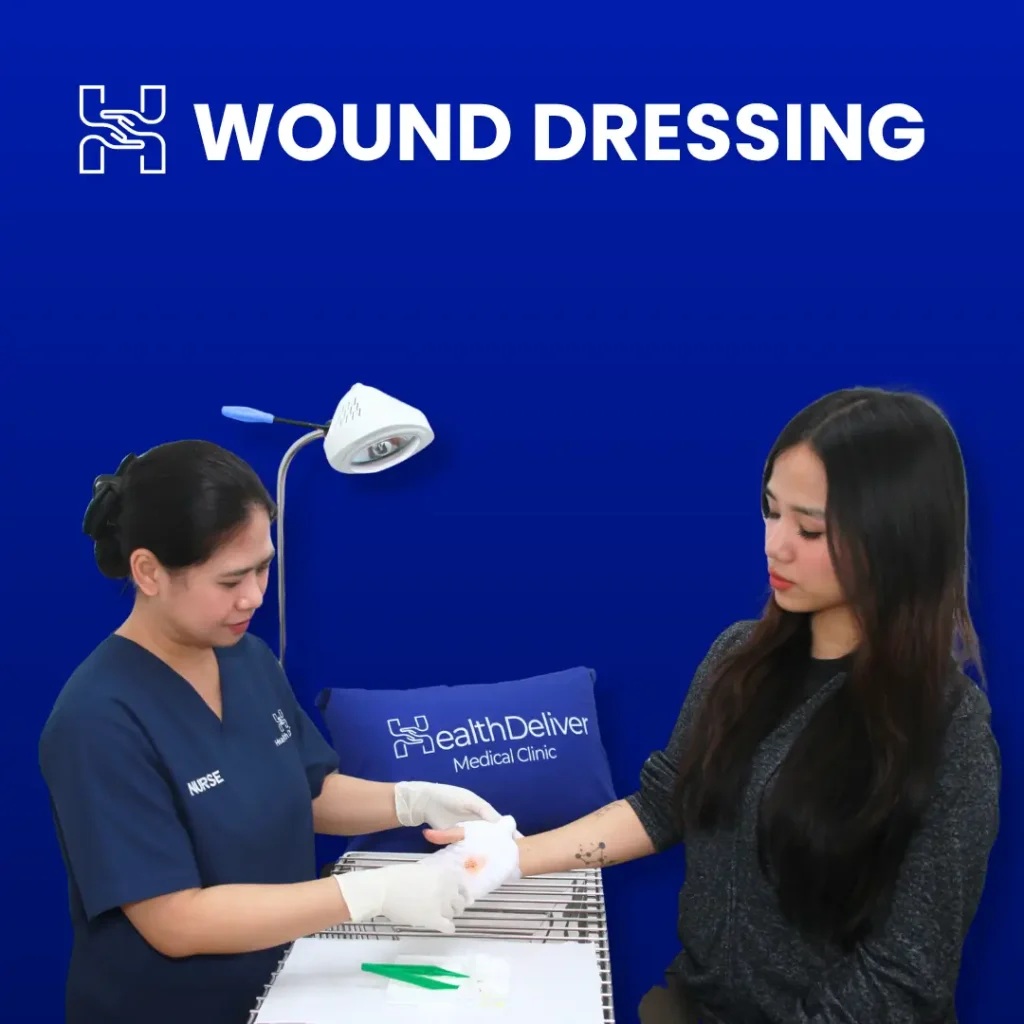 Nurse applying wound dressing to patient hand at medical clinic